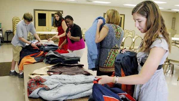 Circle K members Brady Bouldin, Kaylee Ann Smith, Kayla Frye, Valerie Roney and Jessica New sort donated coats collected as part of the club’s drive to provide coats to Pike County residents this winter.