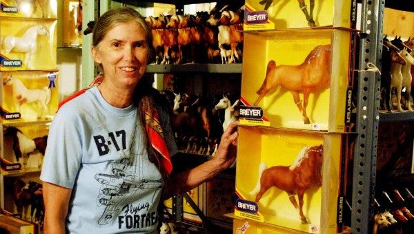 Walter stands by part of her extensive collection of horses.