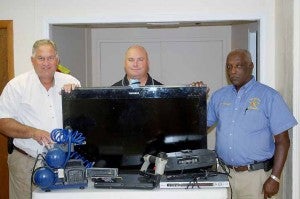Pike County Sheriff Russell Thomas, Investigator Troy White and Frank Wheeler stand with property recovered after a recent burglary in the Tennille community. 