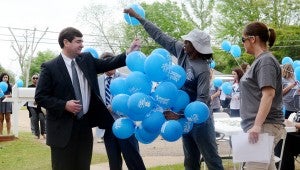 Messenger Photo/Courtney Patterson Mayor Jason Reeves accepts a blue balloon to participate in the balloon release at the Child Advocacy Center during Proclamation Day.