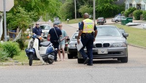 Messenger photo/Courtney Patterson A gray BMW collided with a male riding a moped at the intersection of John M. Long Drive and Folmer street yesterday around 1 p.m. The moped driver had some minor injuries, but none were life-threatening
