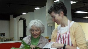 Messenger Photo/Jaine Treadwell Studio 116 on Main Street in Brundidge hosted a Spring Plant Swap Saturday. Sara Dismukes, Studio 116 co-director, right, is pictured with Alice Hayes of Troy whose swap was a sack of old-fashioned freesias, a variety of canna lilies that are much more fragrant than the more modern hybrids.