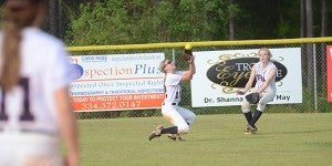 No. 12 Kayla Dendy gets under a fly ball hit by a Monroe player. Mya Terry extends her glove to provide Dendy with back up on the play. The Lady Pats  came back in the seventh inning to beat the Volunteers and win their region.  MESSENGER PHOTO/SCOTTIE BROWN