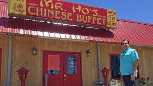 Photo/ Robbyn Brooks Taylor Mr. Ho’s Chinese Buffet is under new ownership. Nijay Nagpal owned the restaurant for 18 years and signed it to the new owner, Qu Yong Weng, pictured, on May 1.