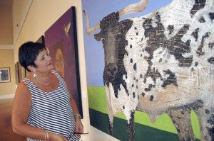 Messenger photo/Jaine Treadwell Sherry Helms visited the Johnson Center Tuesday to view the artwork of Kelly Olszyk, the 2014 TroyFest Best of Show award winner, and award-winning Tuscaloosa sculptor Craig Wedderspoon. She is pictured with Olszyk’s painting of a bull. The Johnson Center will host a reception for Olszky and Wedderspoon from 5 until 7 p.m. Thursday. The public is invited. 