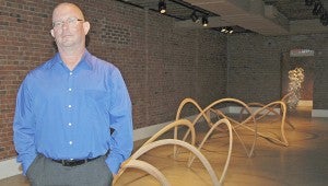 Messenger Photo/Jaine Treadwell Craig Wedderspoon, a highly acclaimed sculptor, stands with his walnut and ash wood sculpture that is part of his “Oval” exhibit at the Johnson Center for the Arts.