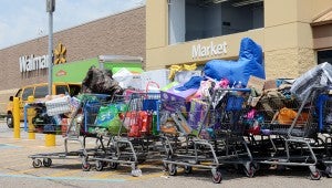 MESSENGER PHOTO/COURTNEY PATTERSON Workers roamed the stores to find items that could be salvaged, storing them in shopping carts outside of the store. Roughly 20 carts were outside the store.