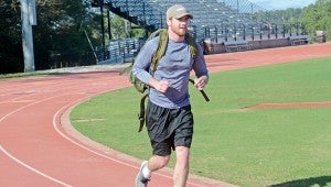 MESSENGER PHOTO/COURTNEY PATTERSON Troy University students participated in the second annual Troy for Troops Ruck-a-Thon Wednesday. Students carried a 20-pound ruck sack on their backs while they ran laps around the university track.