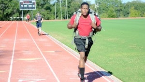 MESSENGER PHOTO/COURTNEY PATTERSON Troy University students participated in the second annual Troy for Troops Ruck-a-Thon Wednesday. Students carried a 20-pound ruck sack on their backs while they ran laps around the university track.