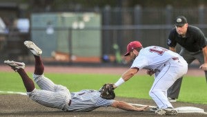 Photo/joey meredith Troy first baseman Trevor Davis tries to put a tag on a Mississippi State runner on Wednesday night at Riddle-Pace Field. The Trojans wrapped up their mid-week game schedule with a 7-3 loss to the third-ranked Bulldogs. 