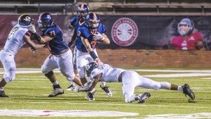 Photo/mike hensley Jabronski williams runs the ball for the Trojans on Friday night against Greenville.  Williams and the Trojans defeated Greenville 37-26 picking up their first win of the season.