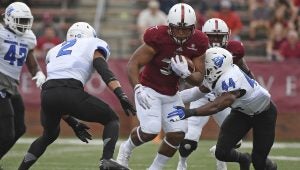 Photo/thomas graning The Troy Trojans improved to 5-1 on the season when they defeated the Georgia State  Panthers 31-21 on Saturday for homecoming. Above: Josh Anderson runs the ball for the Trojans. Inset: William Lloyd attempts to make a tackle against a Panther ball carrier.