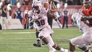 Messenger Photo/joey meredith Jordan Chunn runs the ball for Troy in their victory over South Alabama last Thursday evening.